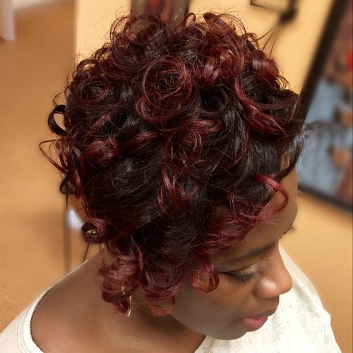 къс curly black hairstyle with burgundy highlights