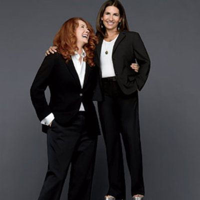 vysoký red headed woman and short brunette in suits